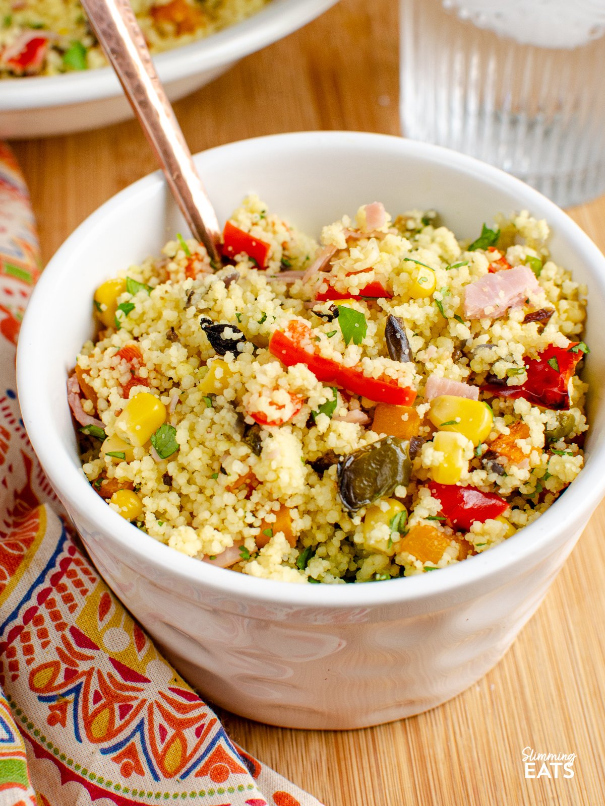 Roasted Vegetables and Ham couscous - sweet roasted peppers, onions, butternut squash and ham with fluffy couscous. serving of Roasted Vegetables and Ham Couscous in white bowl