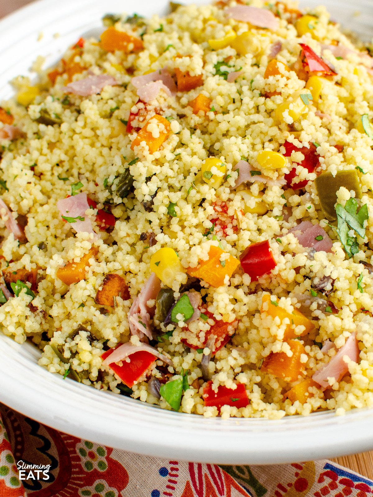 Roasted Vegetables and Ham couscous - sweet roasted peppers, onions, butternut squash and ham with fluffy couscous. close up of Roasted Vegetables and Ham Couscous in white bowl