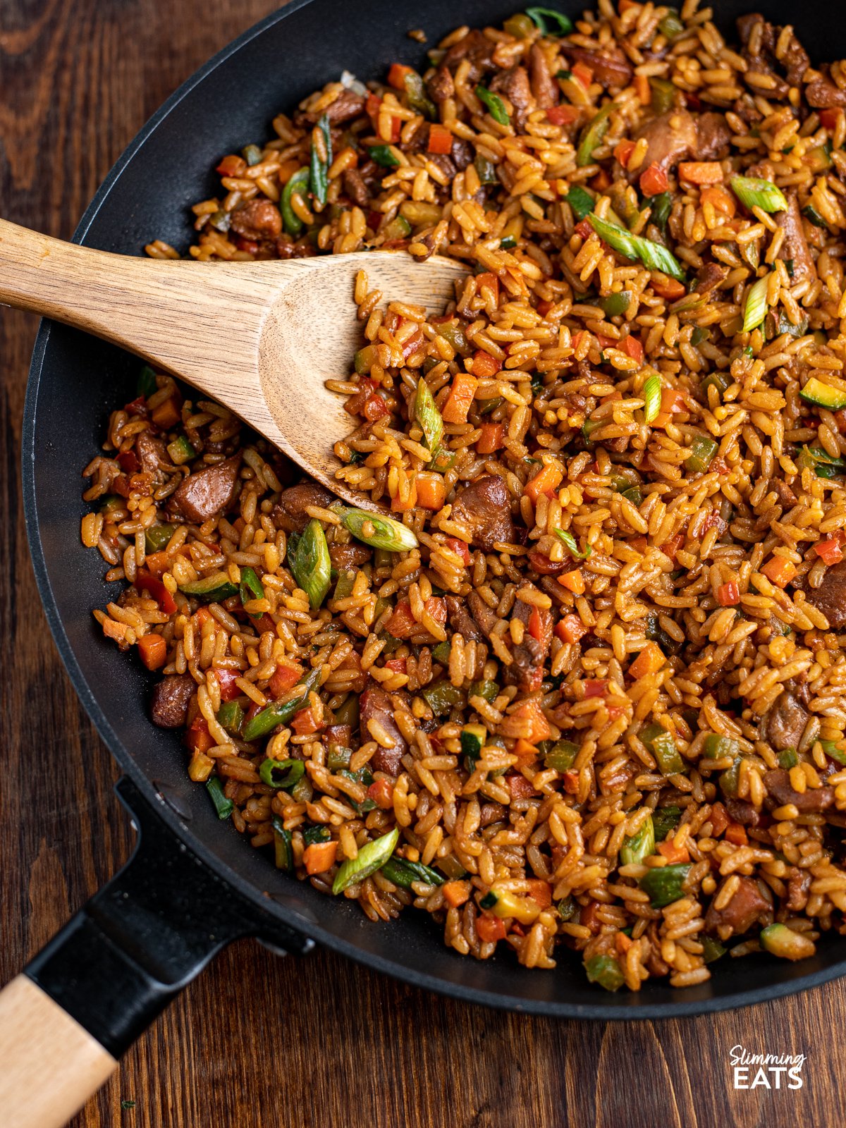 Teriyaki Chicken and Rice Bowl in a black non stick frying pan with wooden handle