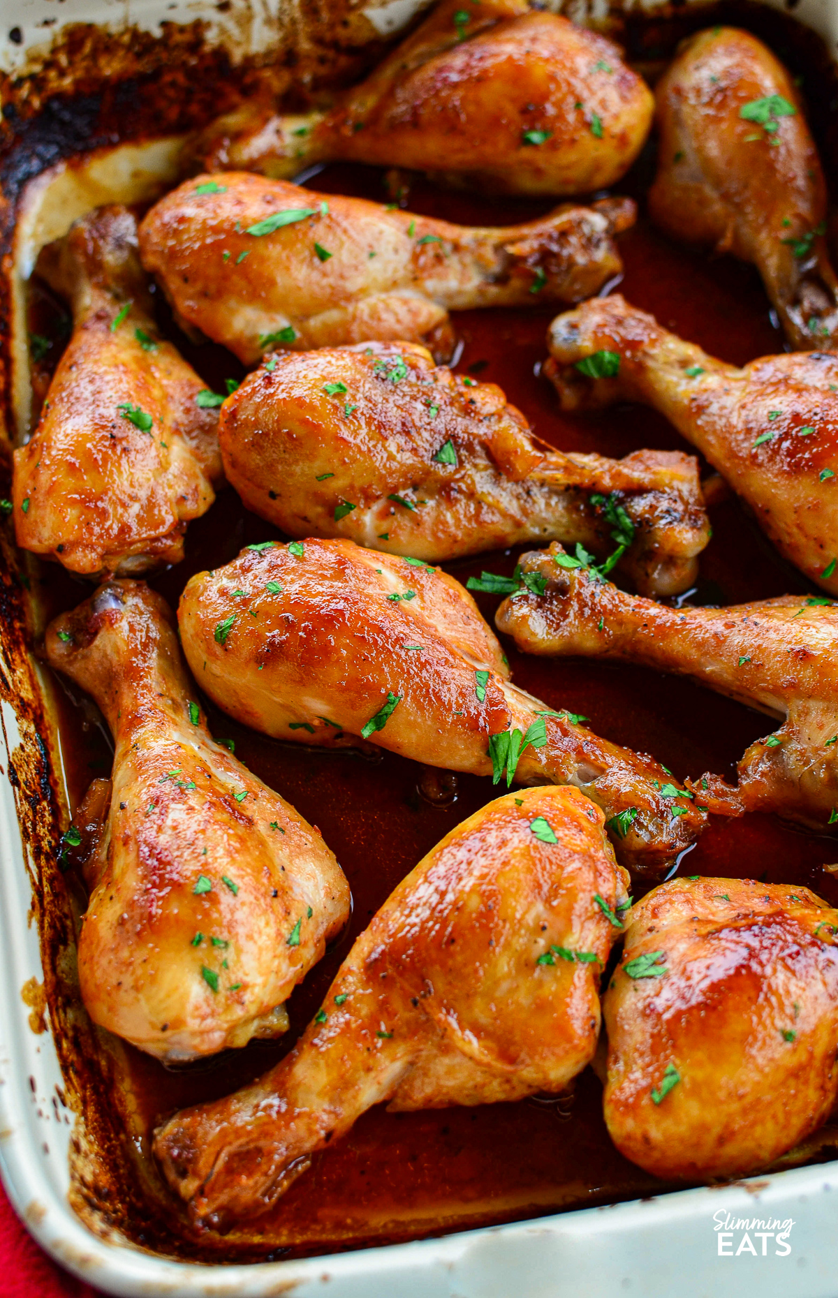 Cooked Maple Glazed Chicken drumsticks in a baking dish