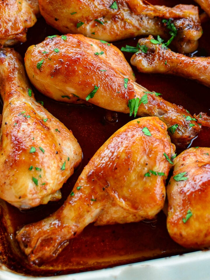 Cooked Maple Glazed Chicken drumsticks in a baking dish