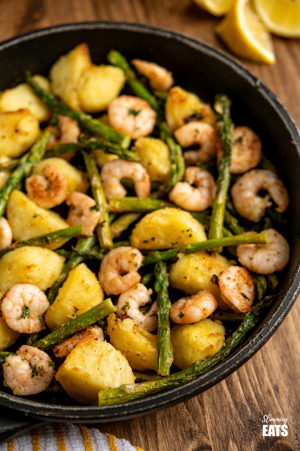 warm asparagus and prawn salad in frying pan