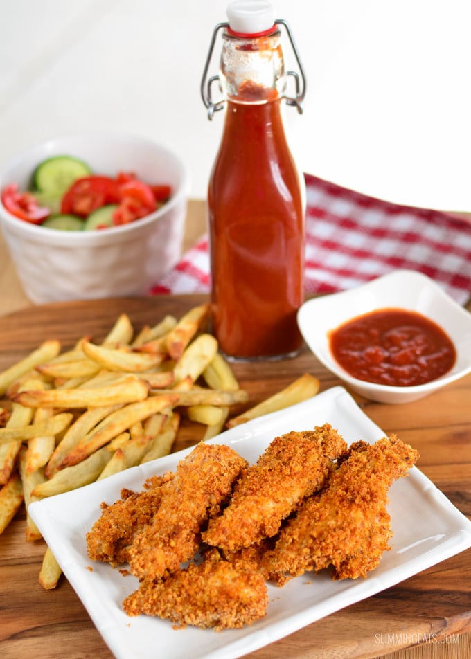 chicken fingers on white rectangle plate with sides