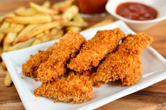 Baked Chicken Fingers on white plate with ketchup and fries