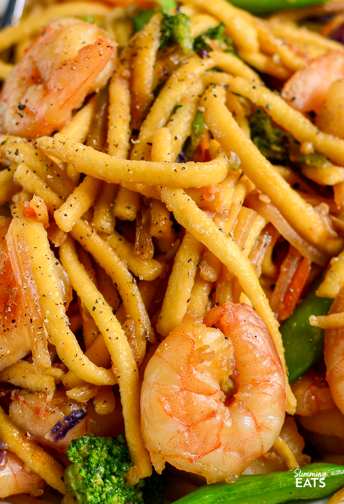 Garlic Ginger Shrimp Noodles - a quick and easy noodle dish packed with juicy shrimp, garlic, fresh ginger and a delicious savoury sauce, all ready in under 20 minutes. It is the perfect busy weeknight dinner. close up of Ginger Garlic Shrimp Noodles