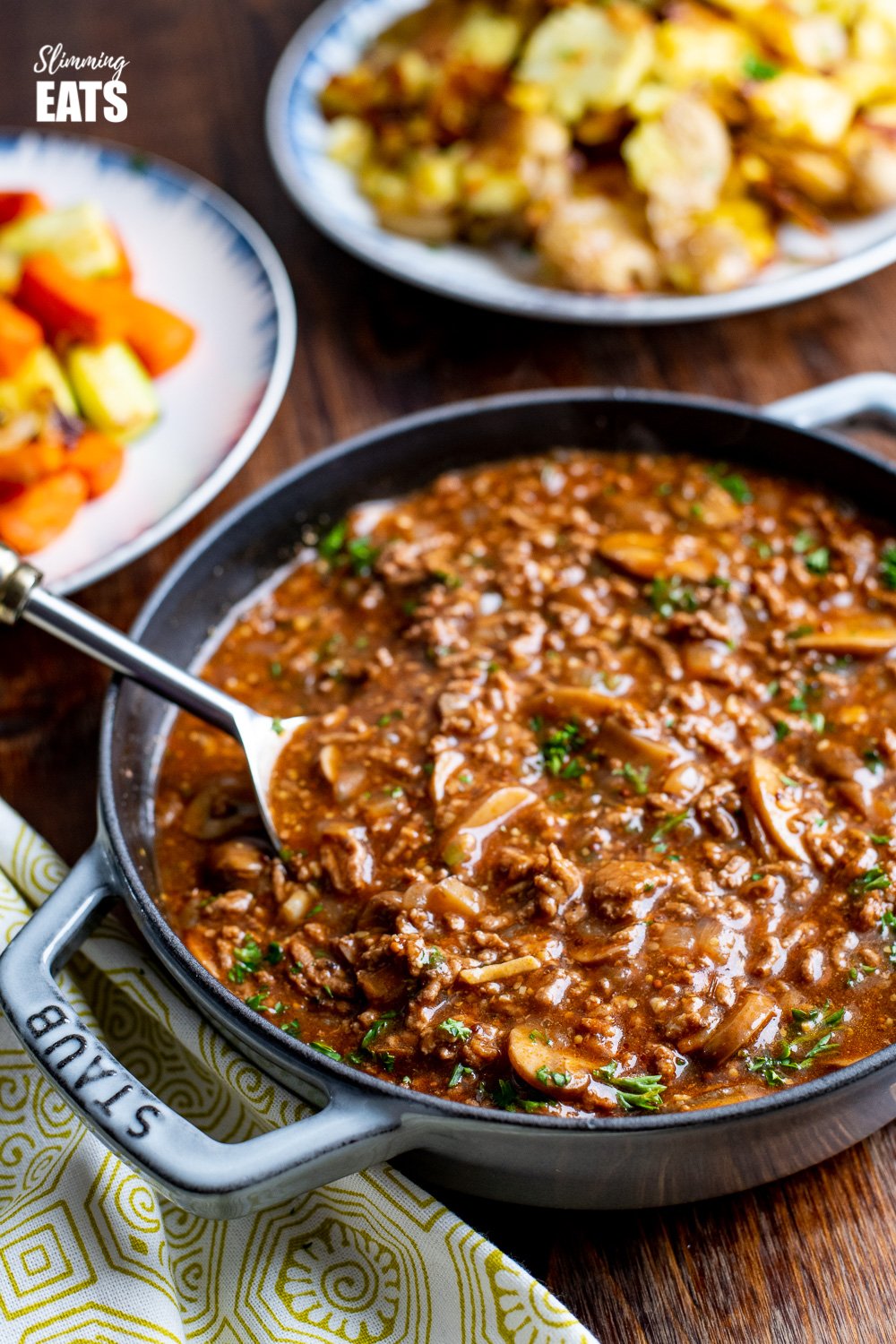 Rich Mustard Beef with Mushrooms in grey cast iron staub skillet