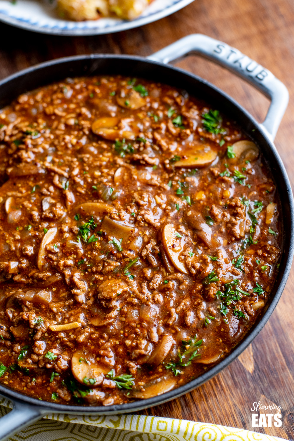Rich Mustard Beef with Mushrooms - the perfect meal for the whole family.#dairyfree #glutenfree #slimming #weightwatchers #beef #paleo #whole30 #beef close up of Rich Mustard Beef in grey staub cast iron skillet