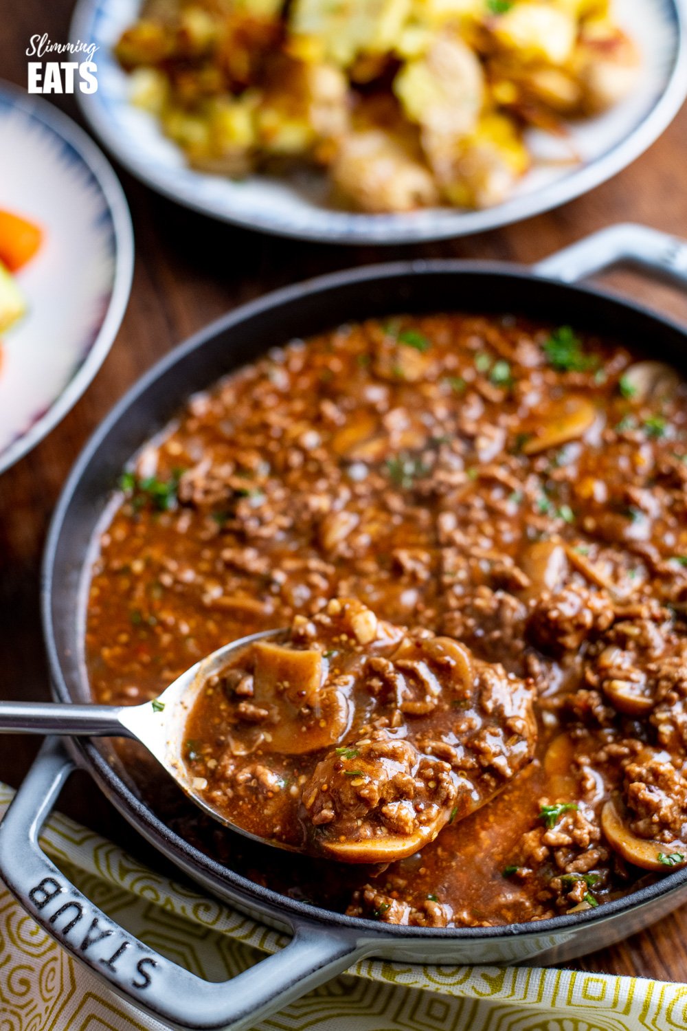 Rich Mustard Beef with Mushrooms in grey cast iron skillet 