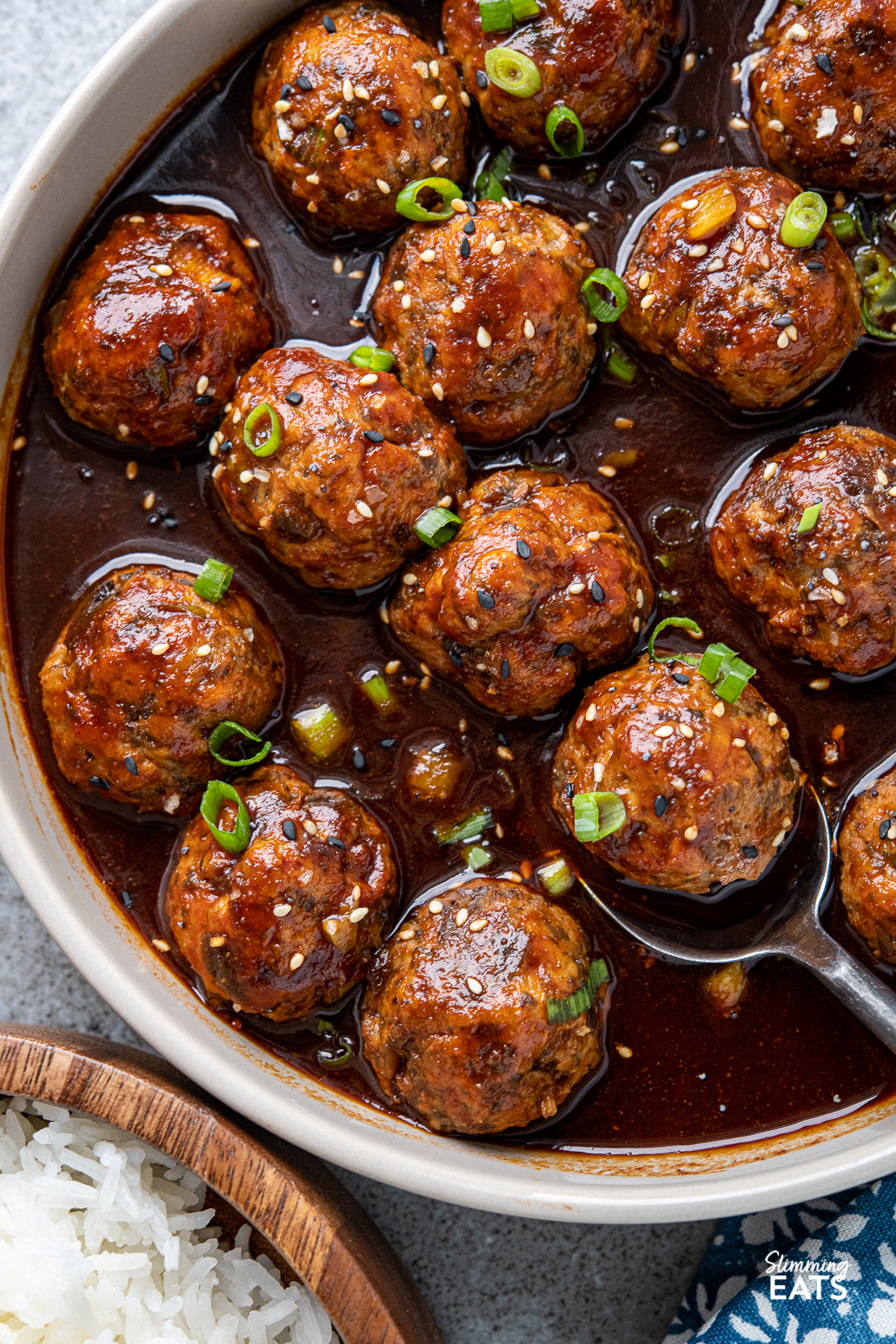 close up of Chicken Meatballs in Hoisin Sauce in brown beige bowl 