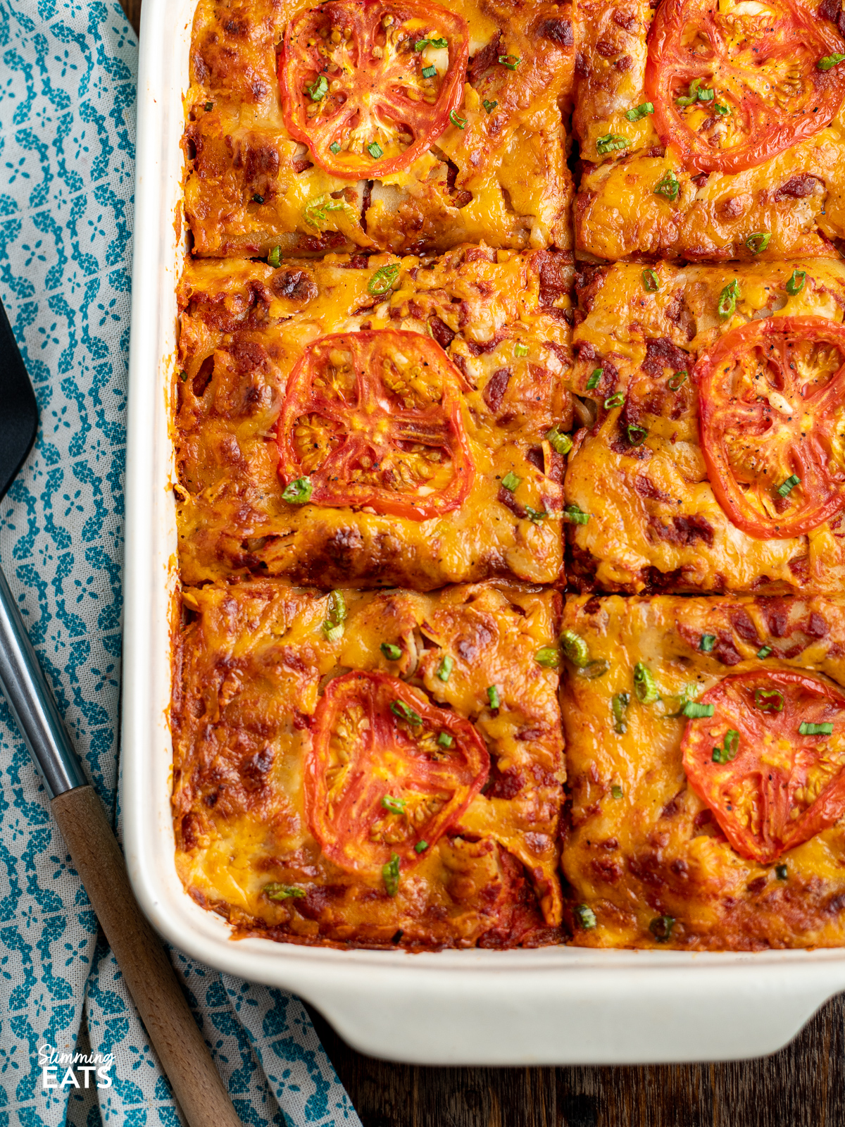 over the top view of portioned up Spicy Mexican Chicken Lasagne in oven baking dish