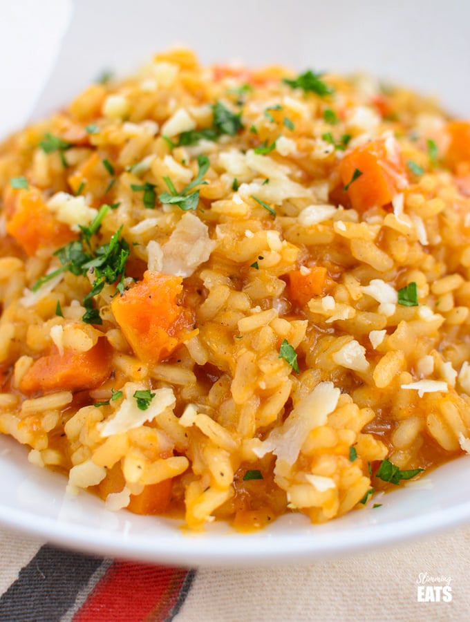 close up of roasted butternut squash risotto in white bowl