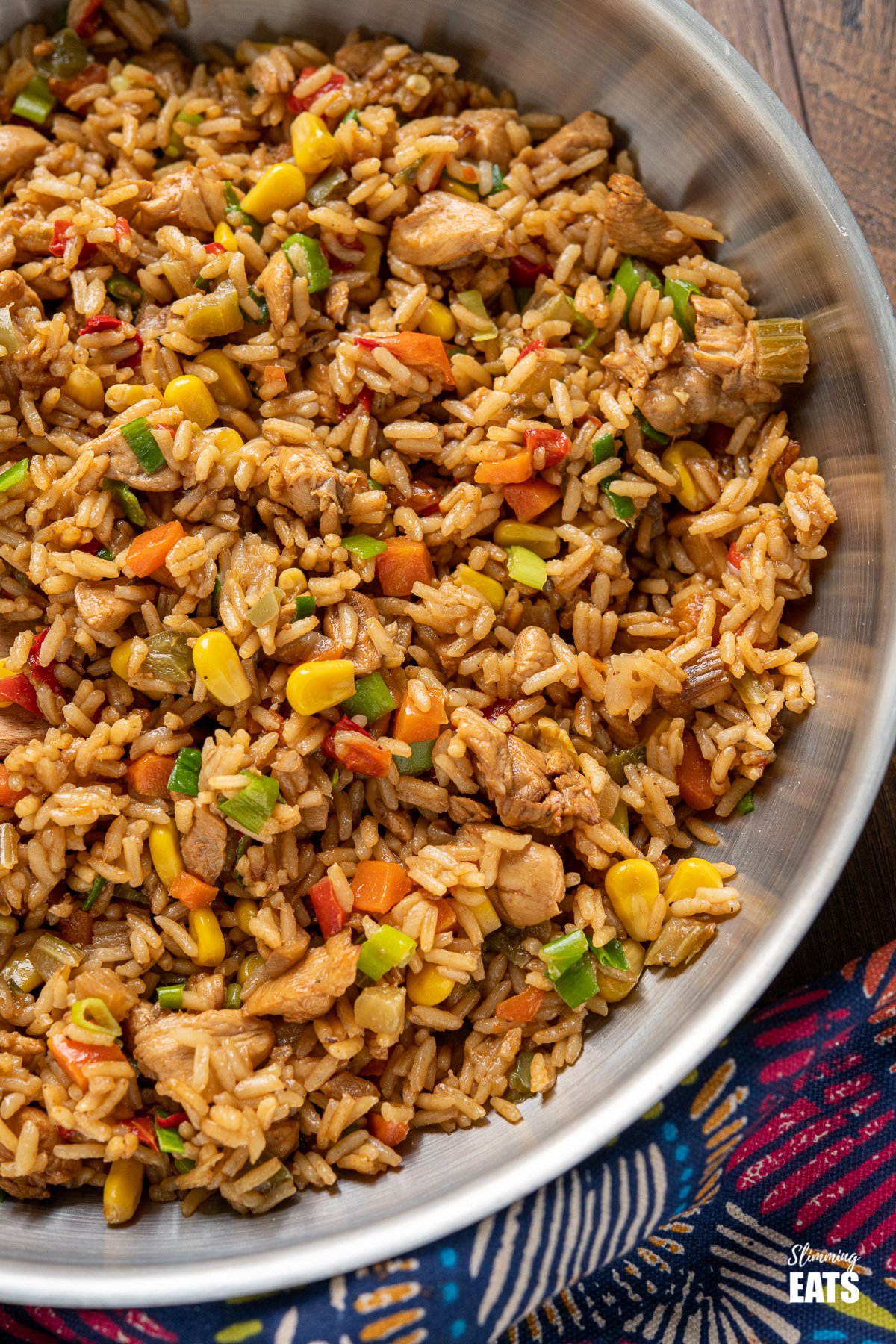 Savoury Rice - An easy one pot recipe with diced chicken breast, vegetables, long grain rice that is a delicious alternative to basic cooked rice and perfect as a main dish or side. #rice #chicken #vegetables #weightwatchers close up of one pot savoury rice in stainless steel frying pan