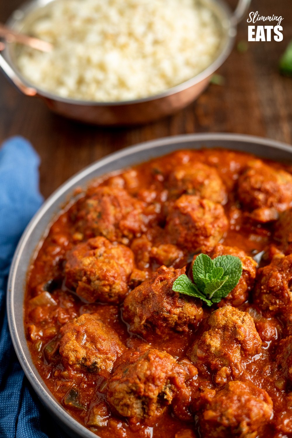 lamb and mint meatballs in a sweet and spicy sauce in a grey bowl on wooden board