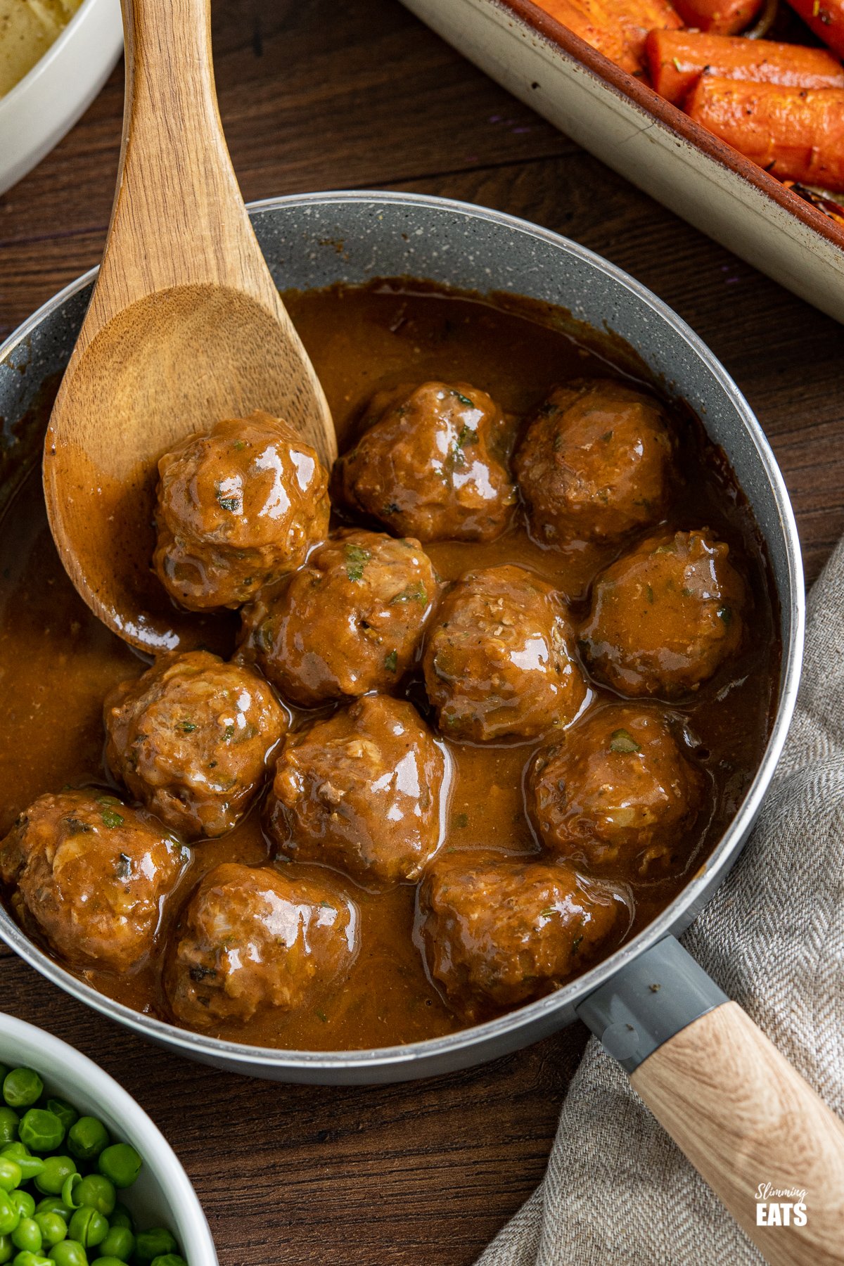 Lamb Meatballs with Mint Gravy - Tender Lamb Meatballs with grated Courgette in a delicious rich mint gravy. Perfect comfort food for the whole family to enjoy. Slimming Eats and Weight Watchers friendly Lamb Meatballs with Mint Gravy in a wooden handled frying pan