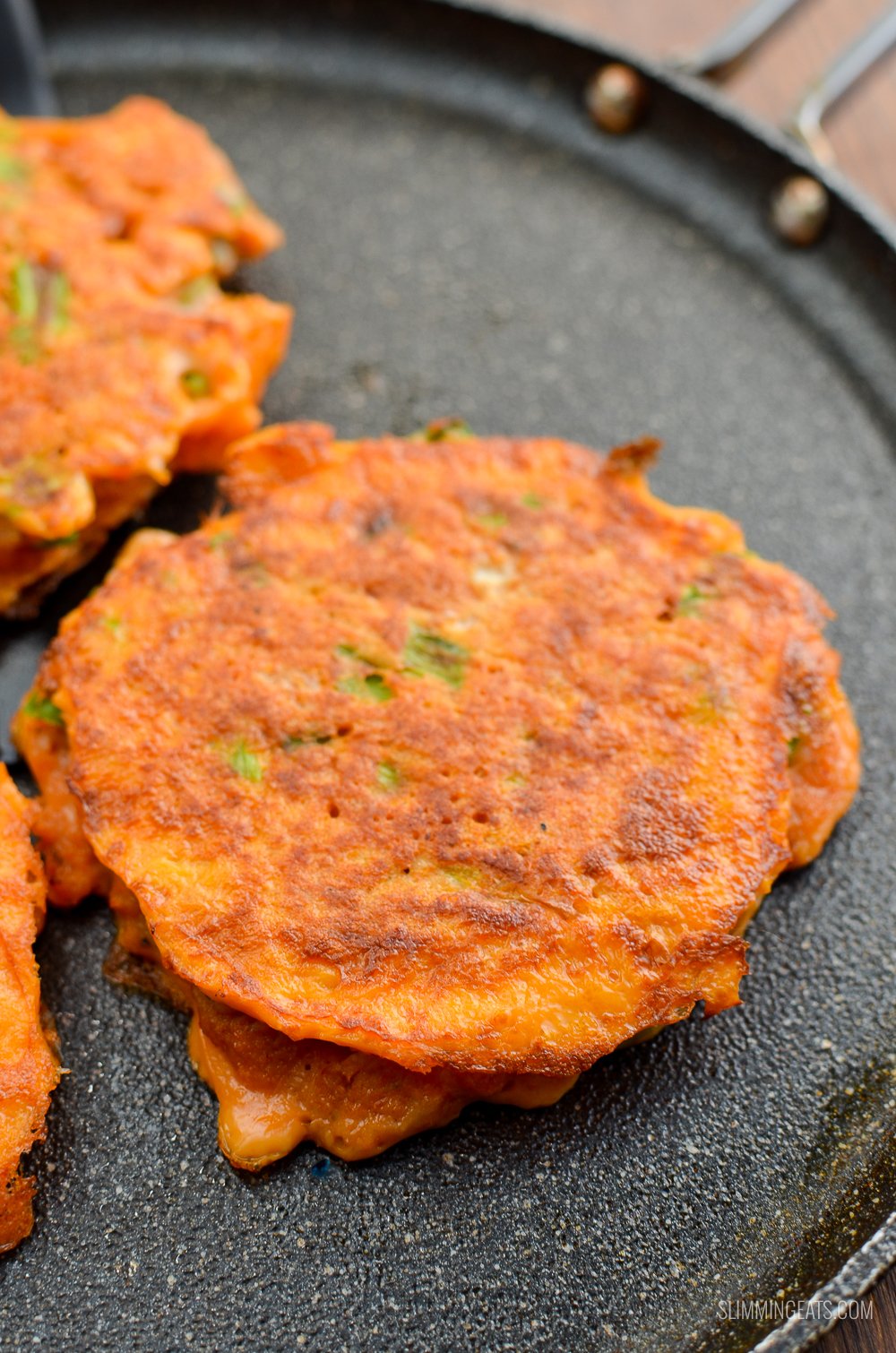 Seriously addictive Thai Crab Cakes for a perfect light meal or appetizer. #slimmingeats #weightwatchers #Thai #crab #glutenfree #dairyfree #paleo close up of Thai Crab Cakes on a skillet