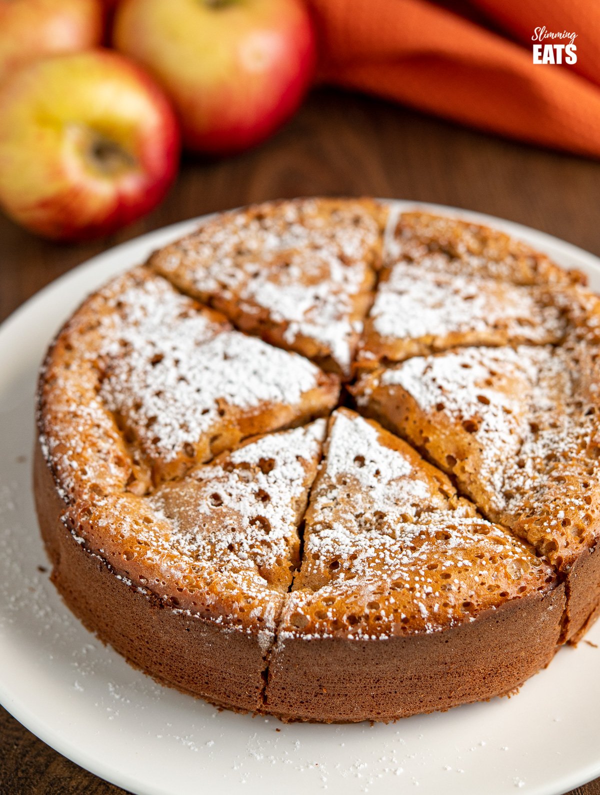 close up of sliced Apple and Sultana Cake on white plate