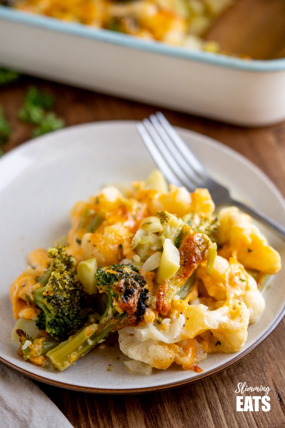 serving of Creamy Cheesy Vegetable Bake on cream coloured plate with brown rim