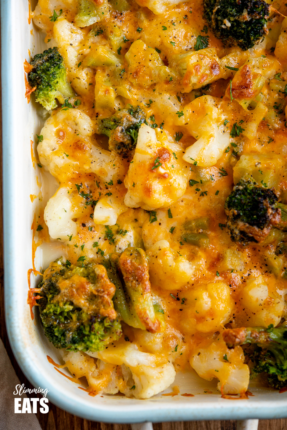 over top close up of Creamy Cheesy Vegetable Bake in enamel baking dish