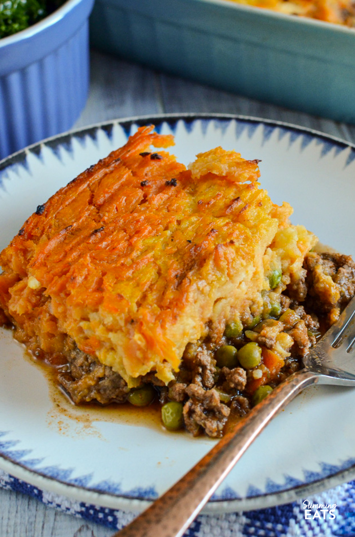 serving of cottage pie on a white plate with blue pattern