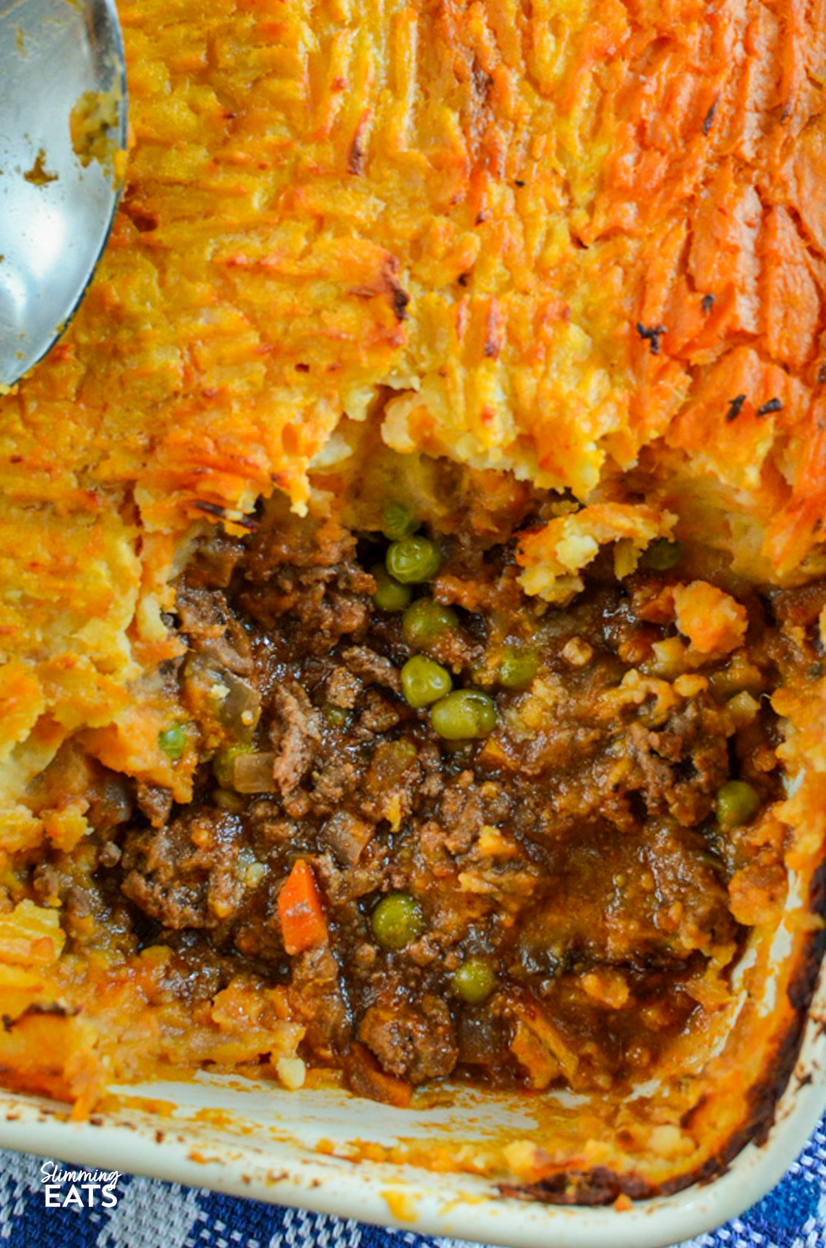 cottage pie in a oven dish with a spoonful removed
