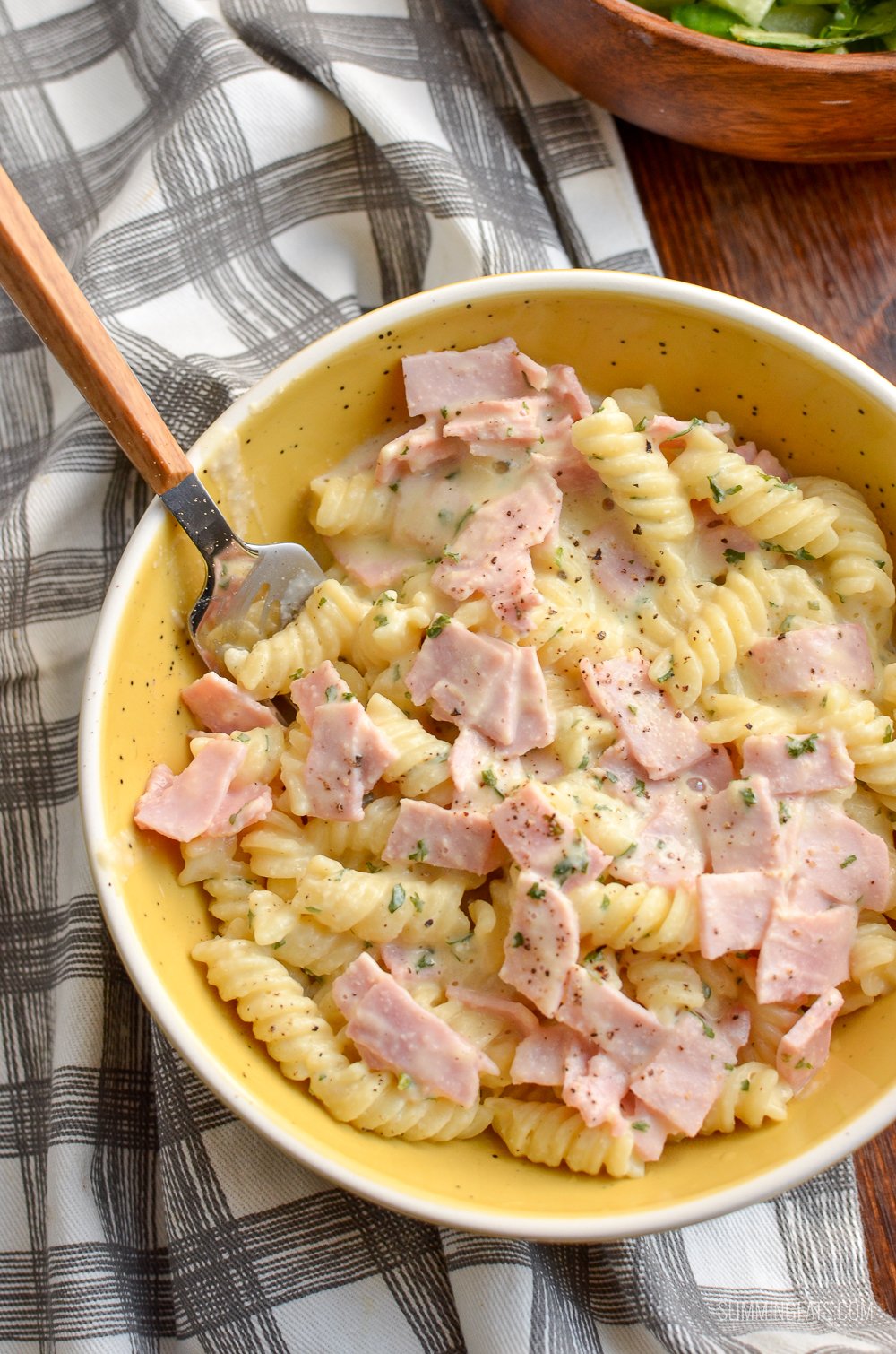 quick creamy pasta in yellow bowl on yellow and grey checked cloth