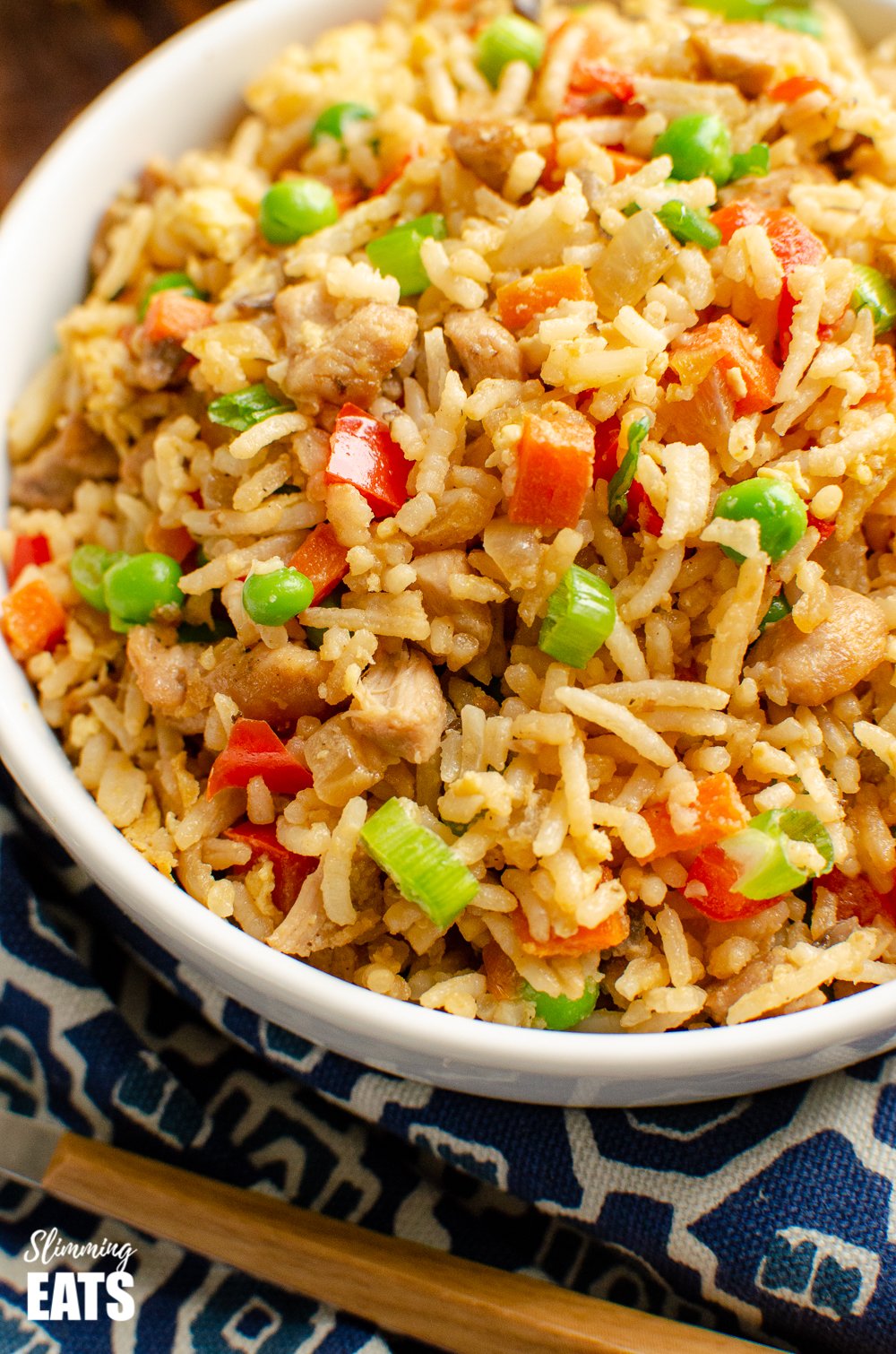 close up of chicken fried rice in white bowl