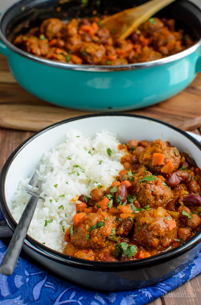 Amazing Indian Spiced Lamb Meatball and Bean Curry with a delicious flavoursome sauce, perfect with a variety of sides and suitable for freezing. Gluten Free, Dairy Free, Slimming Eats and Weight Watchers friendly | www.slimmingeats.com lamb meatball with bean curry in bowl on blue placemat with pan in background