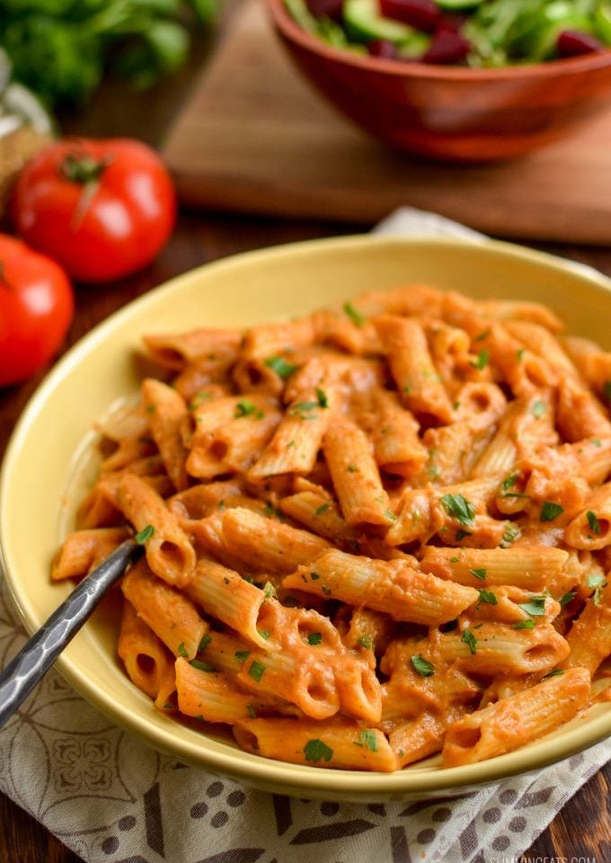 creamy tomato pasta sauce over pasta in a bowl