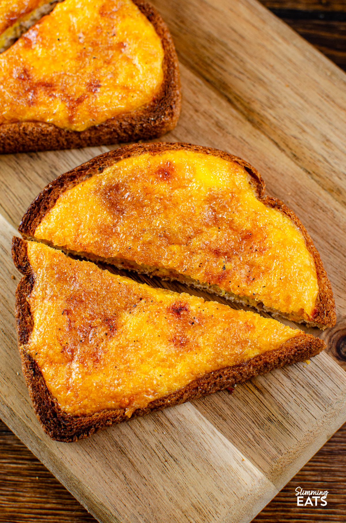 Crispy Cheesy Toast sliced on a wooden board