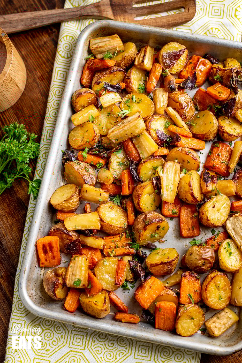 Healthy Delicious Rosemary Roasted Potatoes, Parsnips, Carrots and Onion the perfect addition to any main meal. Gluten Free, Dairy Free, Vegan, Slimming Eats and Weight Watchers friendly Rosemary Roasted Potatoes, Parsnips, Carrots and Onion on a baking tray
