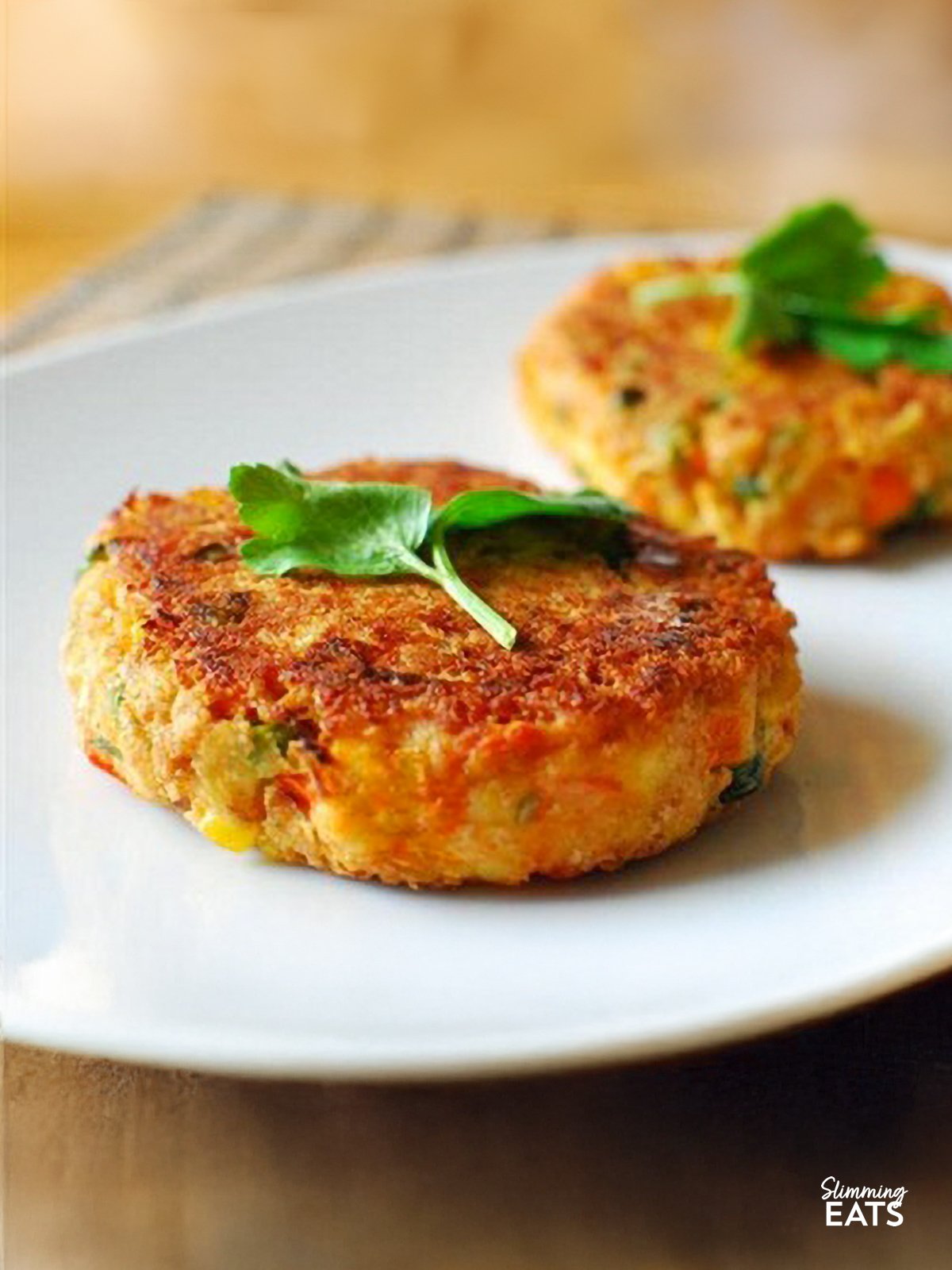 Vegetable and Cheddar Patties Vegetable and Cheddar Patties on white plate with parsley garnish