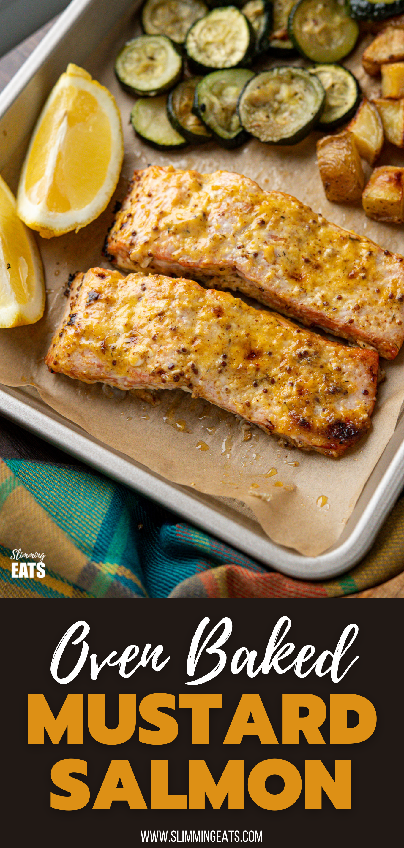 Oven Baked Mustard Salmon Fillets on parchment lined tray with potatoes, zucchini and lemon wedge