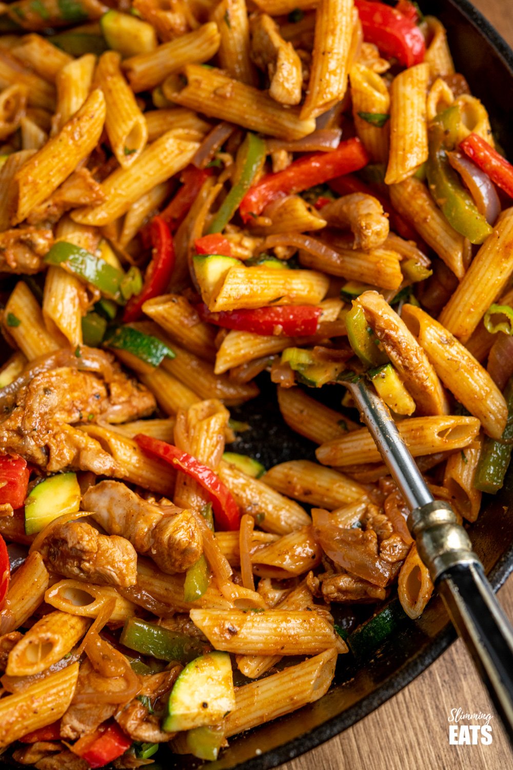 Fajita Chicken Pasta - all the great flavours of chicken fajita's in this amazing pasta dish that the whole family will love. Weight Watchers friendly close up of close up of Fajita Chicken Pasta in a lodge cast iron skillet and spoon