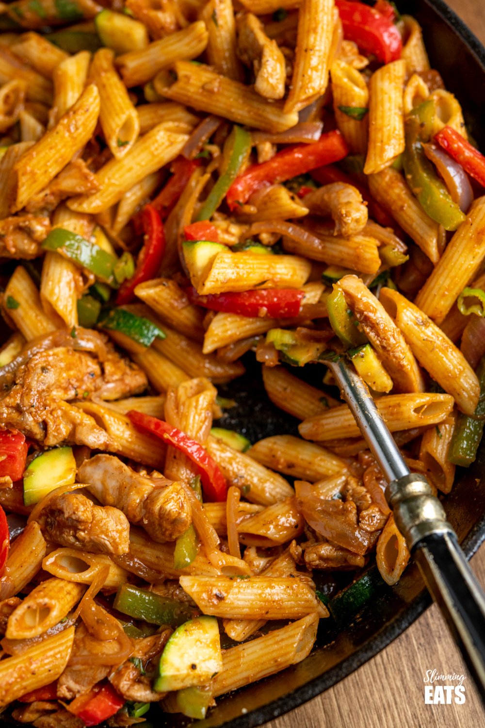 close up of close up of Fajita Chicken Pasta in a lodge cast iron skillet and spoon