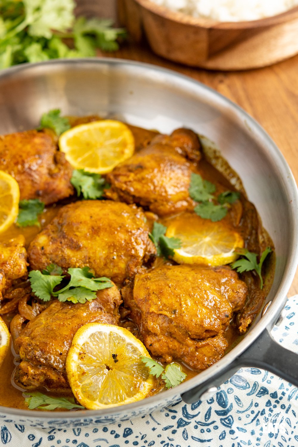 lemon chilli chicken in skillet on wooden table