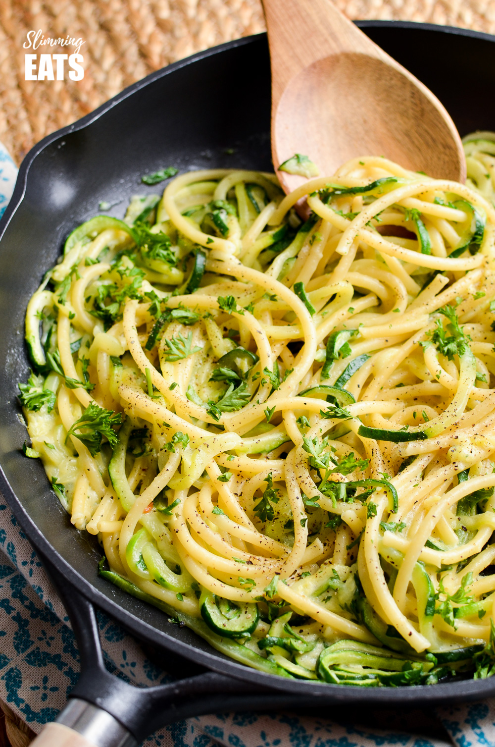 courgette and parmesan pasta in a black frying pan