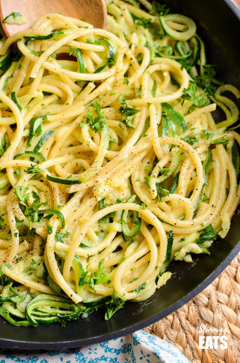 Delicious Syn Free Courgette and Parmesan Pasta - a simple quick pasta recipe with spiralized courgette. Vegetarian, Slimming World and Weight Watchers friendly close up of courgette and parmesan pasta in frying pan