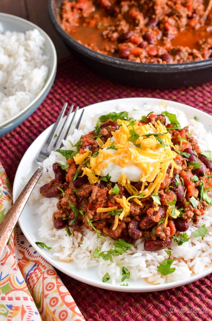 BEST EVER Syn Free Chilli Con Carne - an all time classic family friendly recipe. Pure comfort in a bowl!! Gluten Free, Dairy Free. serving of Chilli Con Carne in bowl over rice with toppings