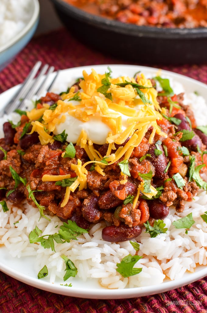 BEST EVER Syn Free Chilli Con Carne - an all time classic family friendly recipe. Pure comfort in a bowl!! Gluten Free, Dairy Free. close up of Chilli Con Carne in bowl over white rice.