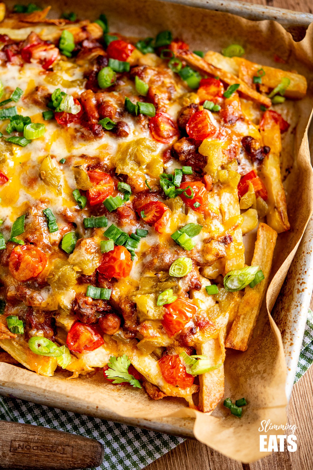 Layered Chilli Cheese Fries on parchment lined baking tray