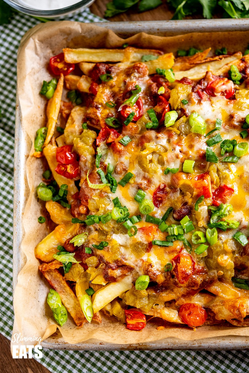 over top view of Layered Chilli Cheese Fries on baking tray