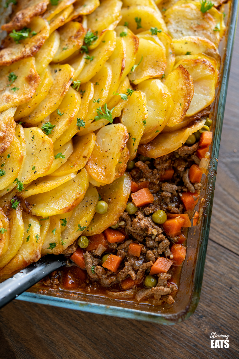 close up of minced beef hotpot crispy potato topped pie in oven proof dish