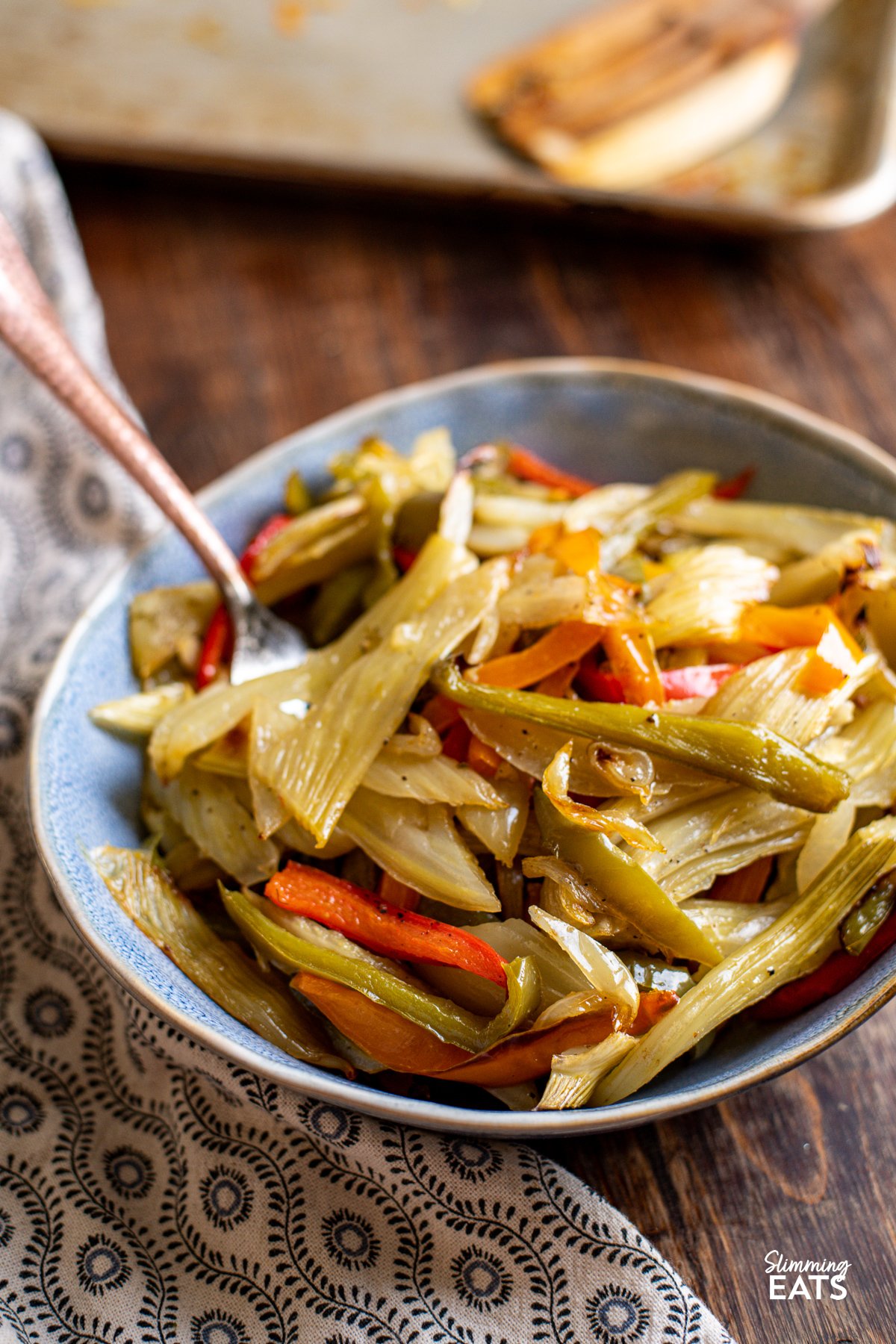 Roasted fennel and peppers is a delicious and nutritious side dish, combining the earthy aniseed flavor of fennel with the sweet essence of bell peppers, all complemented by the aromatic presence of onion and garlic. Roasted Fennel and Mixed Peppers in a bowl