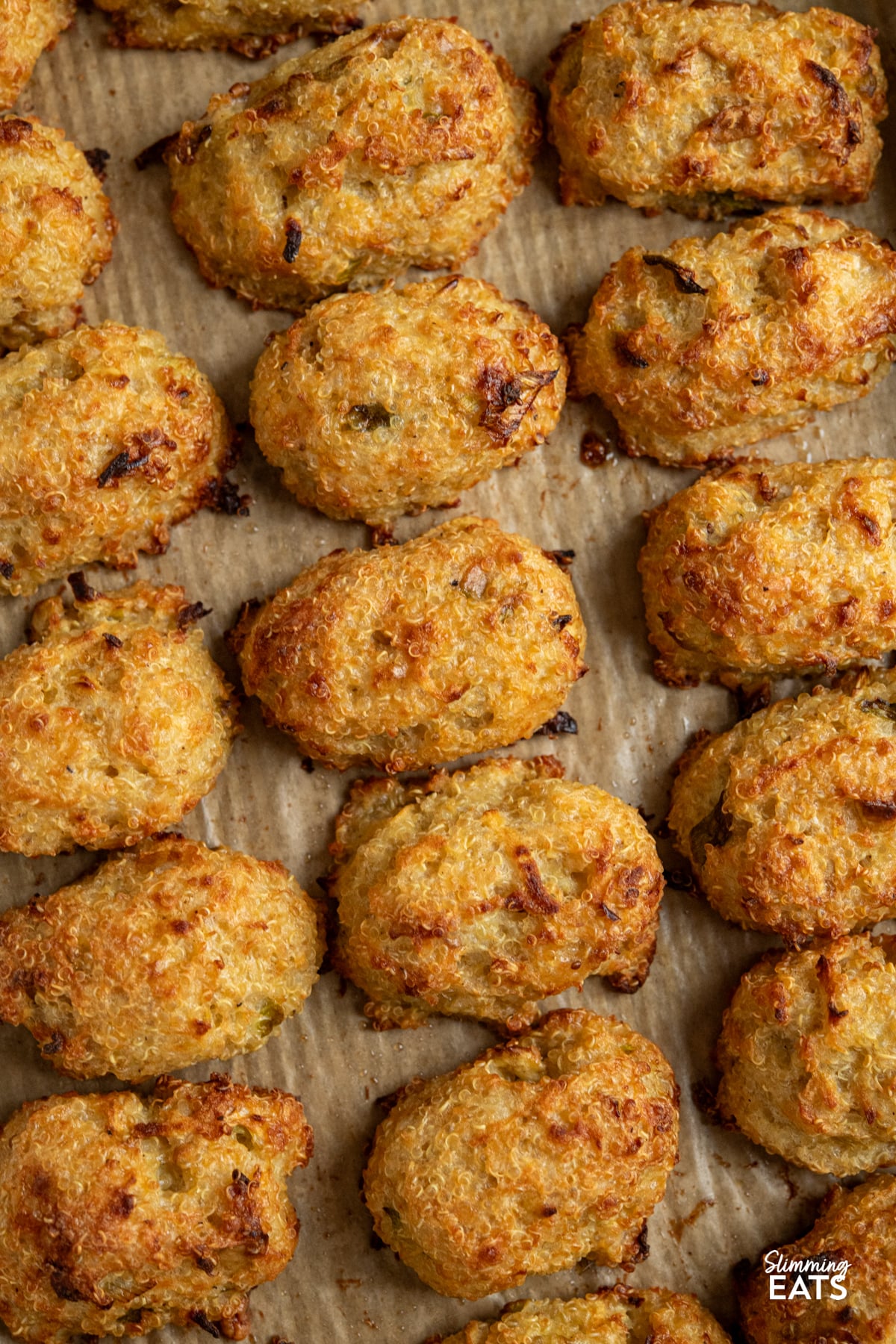 close up of Cheddar Apple Quinoa Bites on a parchment lined baking tray