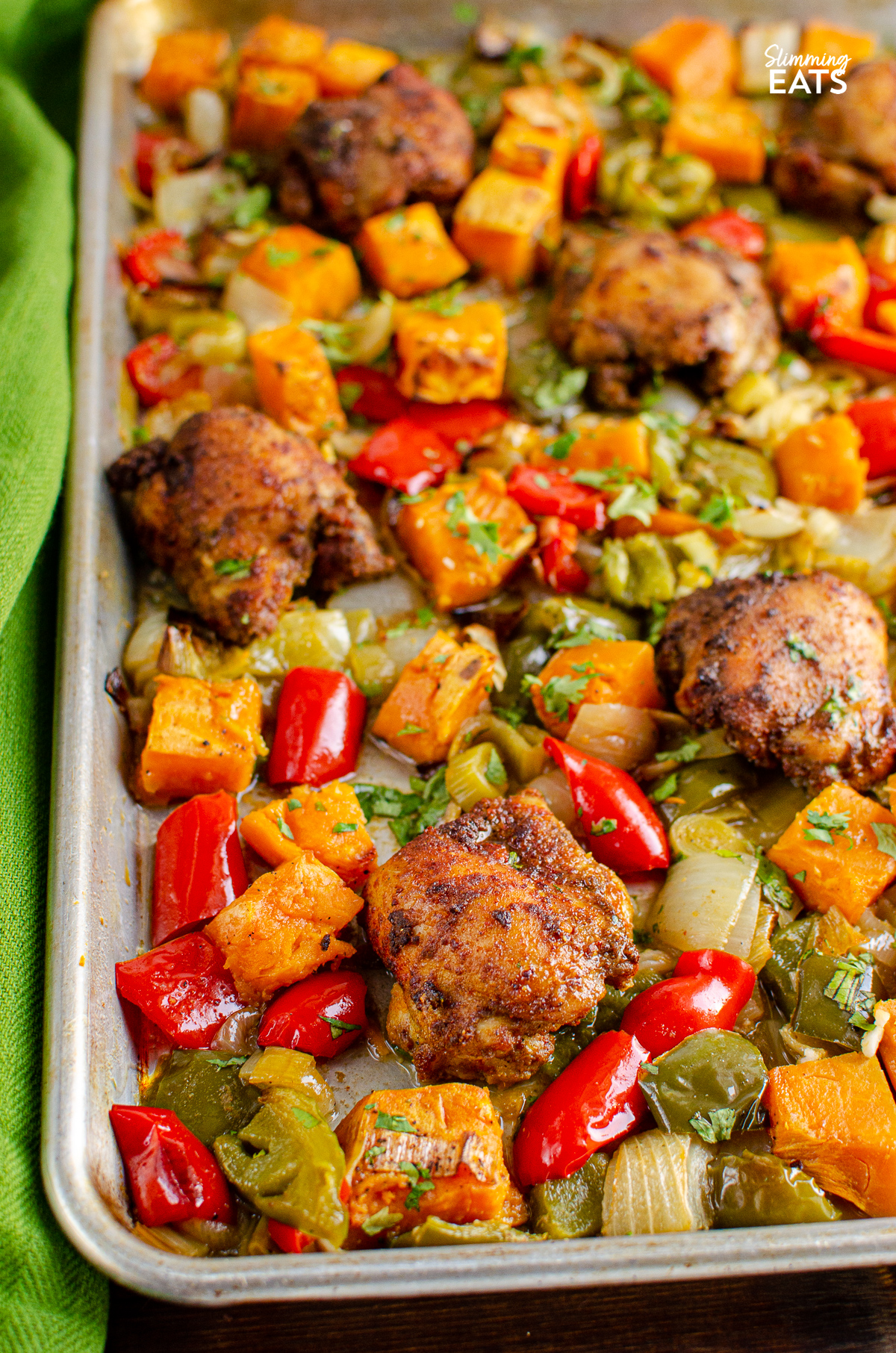 Seasoned Chicken and Roasted Sweet Potato and vegetables baked on a Tray