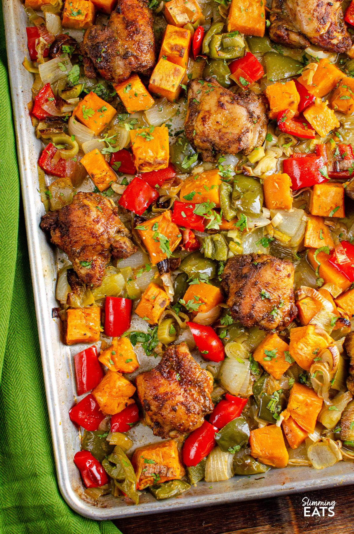 Seasoned Chicken and Roasted Sweet Potato and vegetables baked on a  Tray