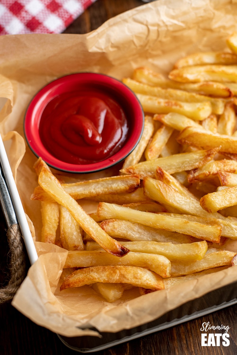 picture of Syn Free chips with ketchup on a white parchment lined tray