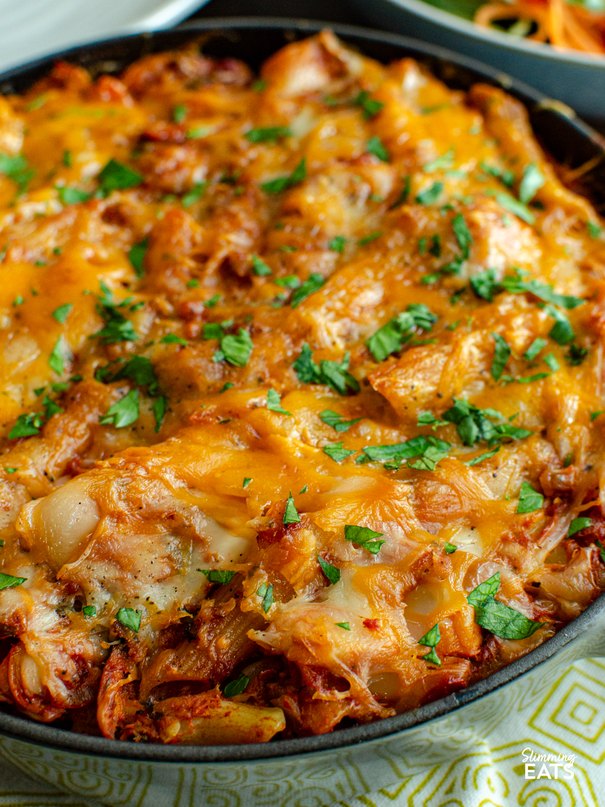 close up of tuna pasta bake in staub grey cast iron skillet.