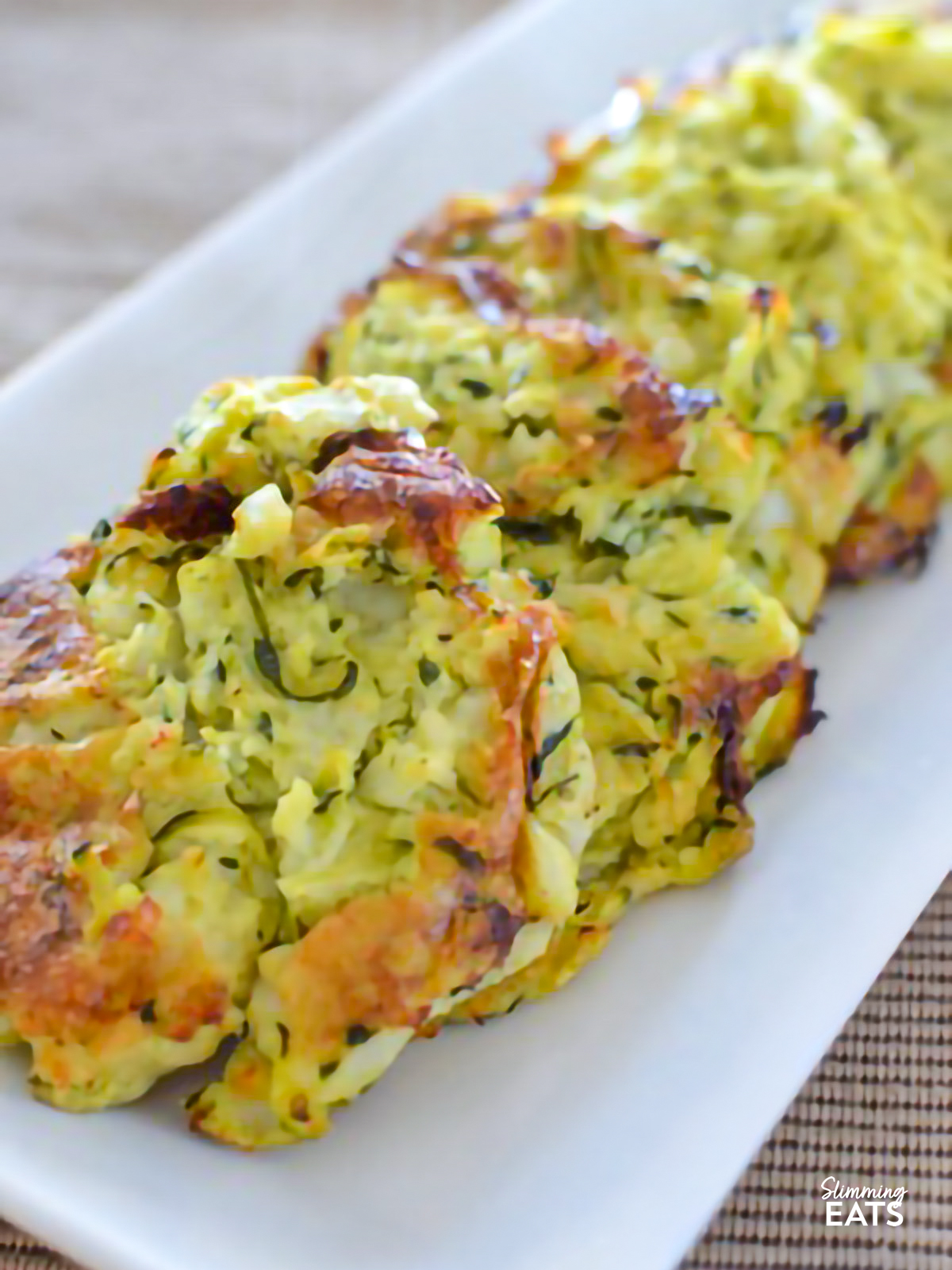 Rustic Courgette and Potato Cakes on a white rectangle plate