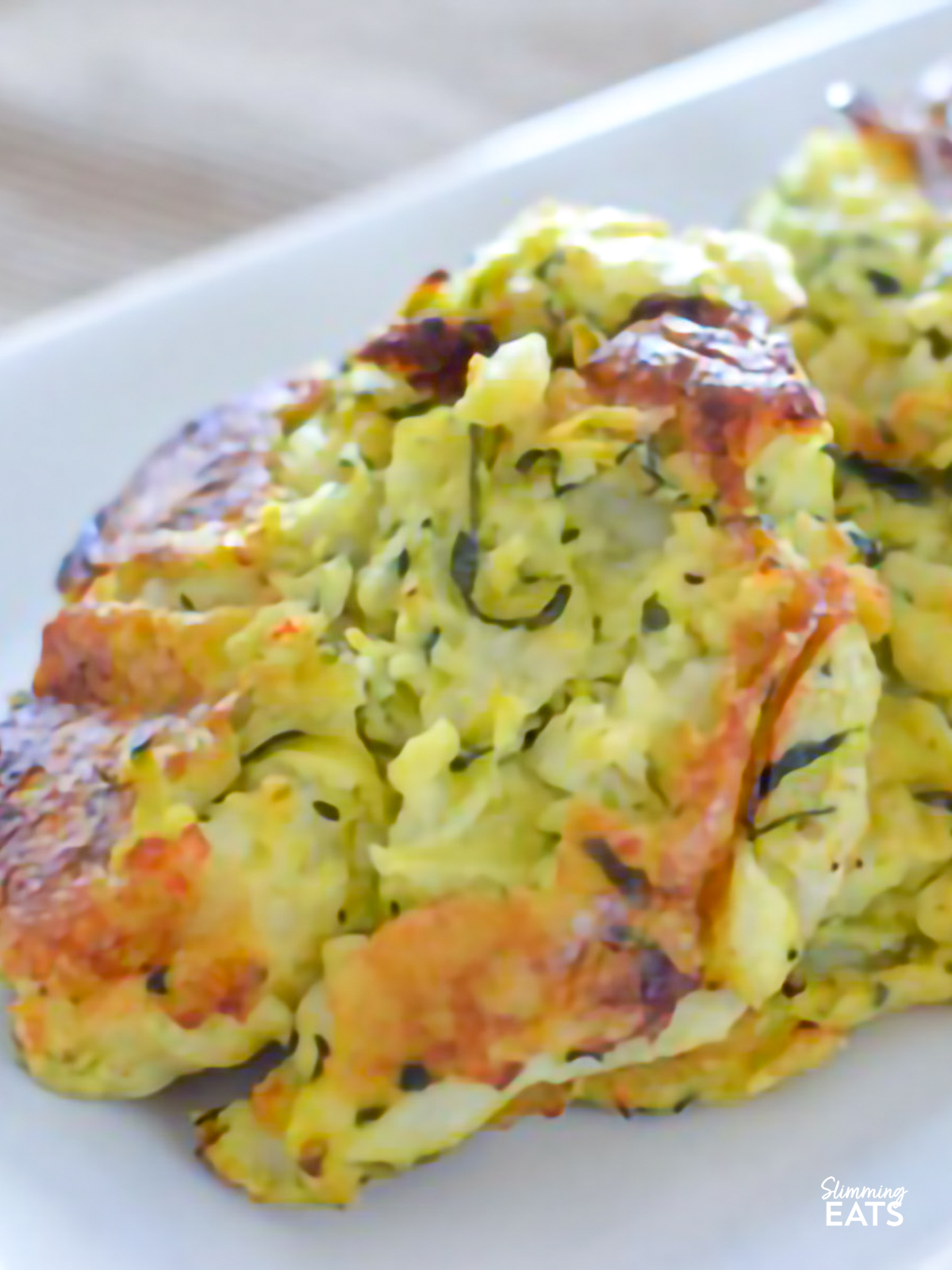 close up of Rustic Courgette and Potato Cakes on a white rectangle plate